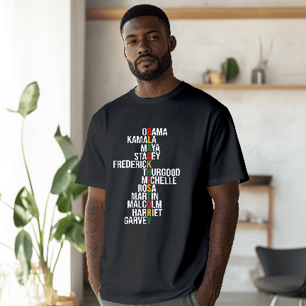 Man wearing a black t-shirt with colorful text in a room with plants and furniture.