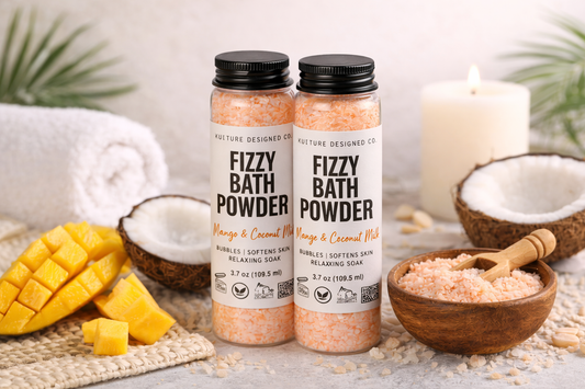 Two bottles of Fizzy Bath Powder with coconuts, mangoes, and a candle on a light background.