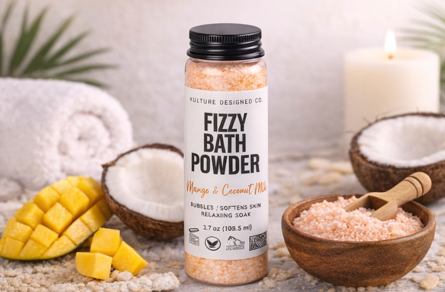 Fizzy bath powder container with mango and coconut elements on a neutral background