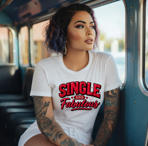 Woman wearing a white t-shirt with 'Single and Fabulous' text on a bus.