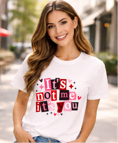 Woman wearing a white t-shirt with colorful text outdoors
