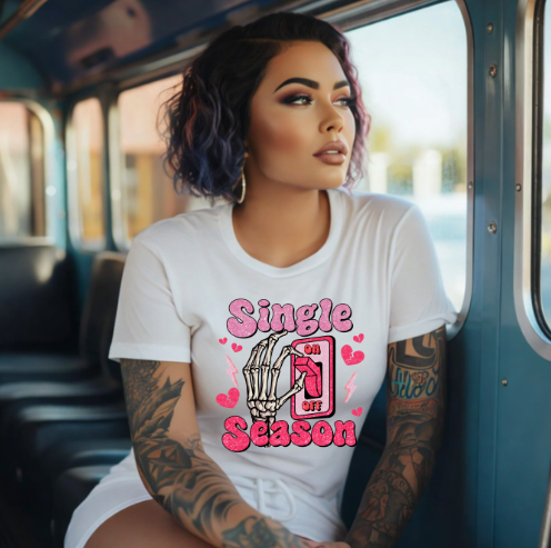 Woman wearing a white t-shirt with 'Single Season' design on a bus.