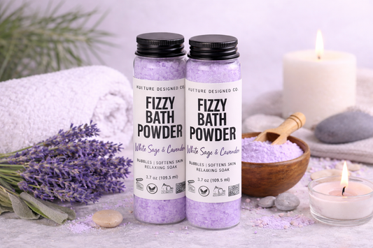 Two bottles of Fizzy Bath Powder with lavender and lavender flowers on a white surface.