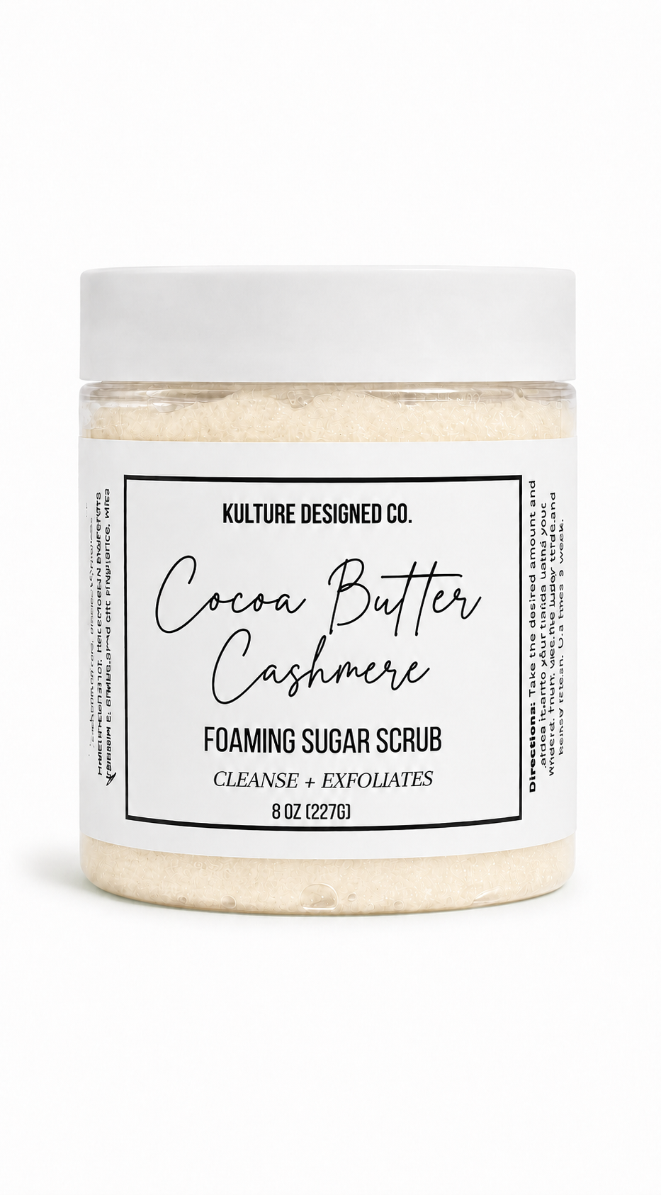 A jar of Kulture Designed Co. Cocoa Butter Cashmere Foaming Sugar Scrub, featuring a white lid and a white label with black text, set against a clean white background.